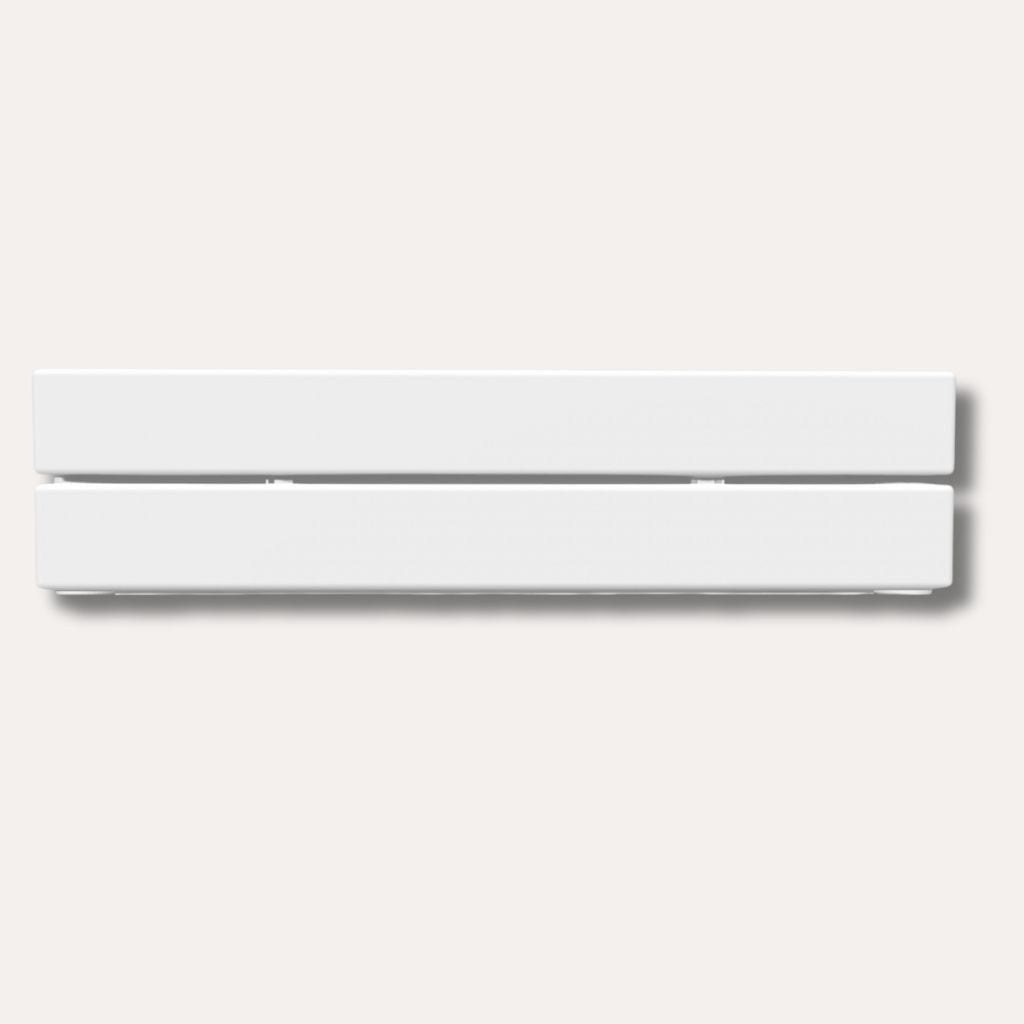 Low architectural hot water baseboard radiator along a wall