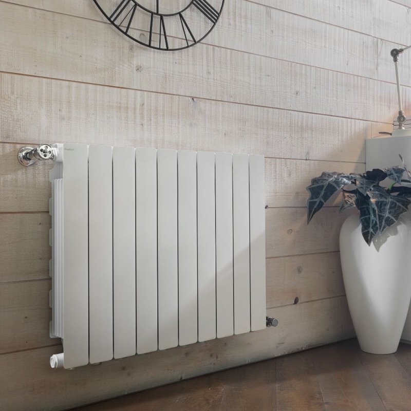 Vertical white hot water radiator in a modern living room